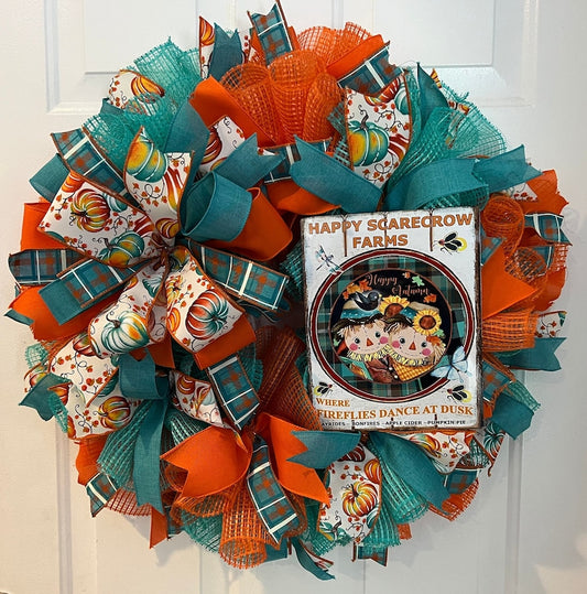 Autumn wreath for a homeowner. Teal and orange, with a large bow and metal sign. Festive and vibrant!